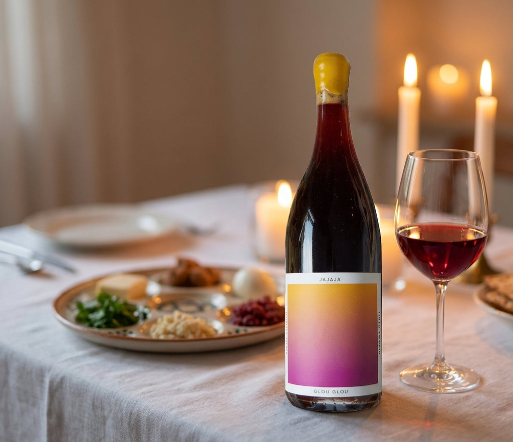 Jajaja Glou Glou red wine bottle on a candlelit Passover Seder table