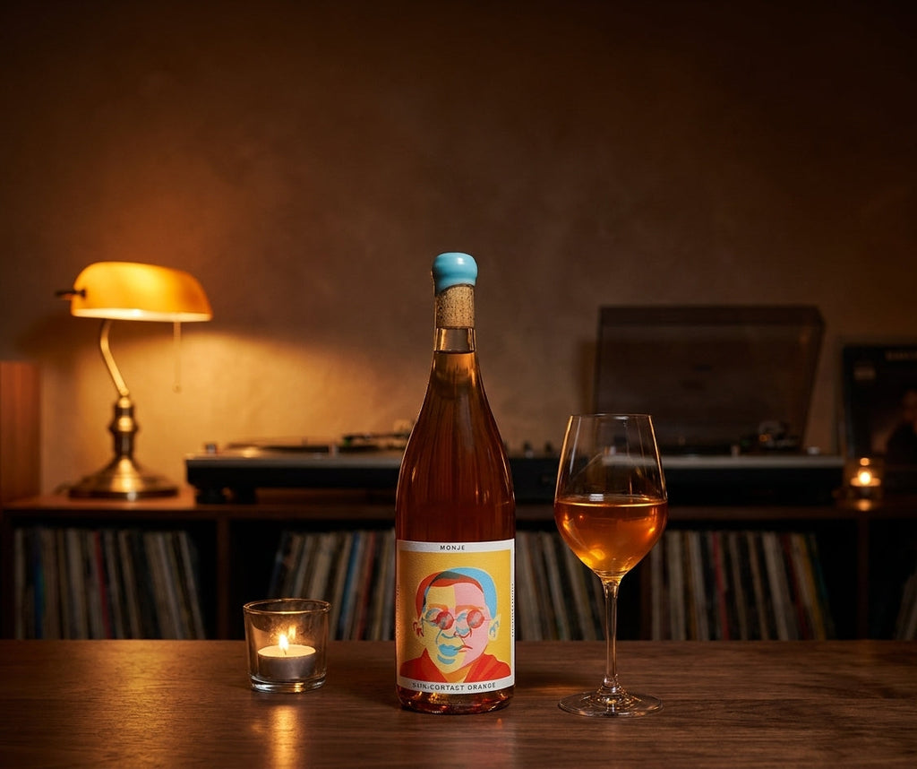 Monje skin-contact orange wine bottle on a listening bar counter in low evening light
