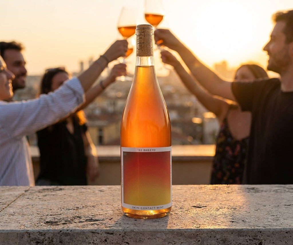 Bheeyo skin-contact orange wine bottle at a golden-hour rooftop happy hour